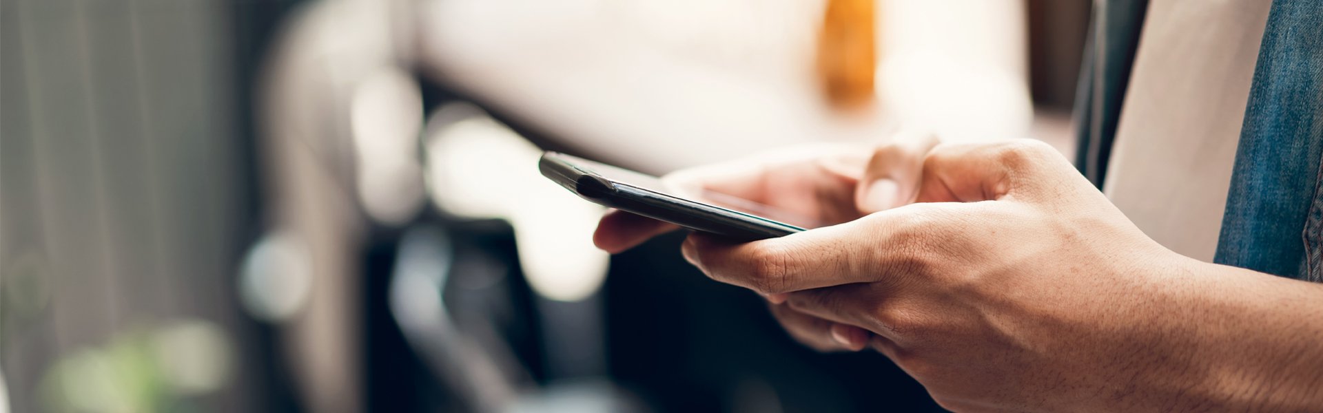Person using a smartphone to access information related to Happy Valley Casino in State College, Pennsylvania.