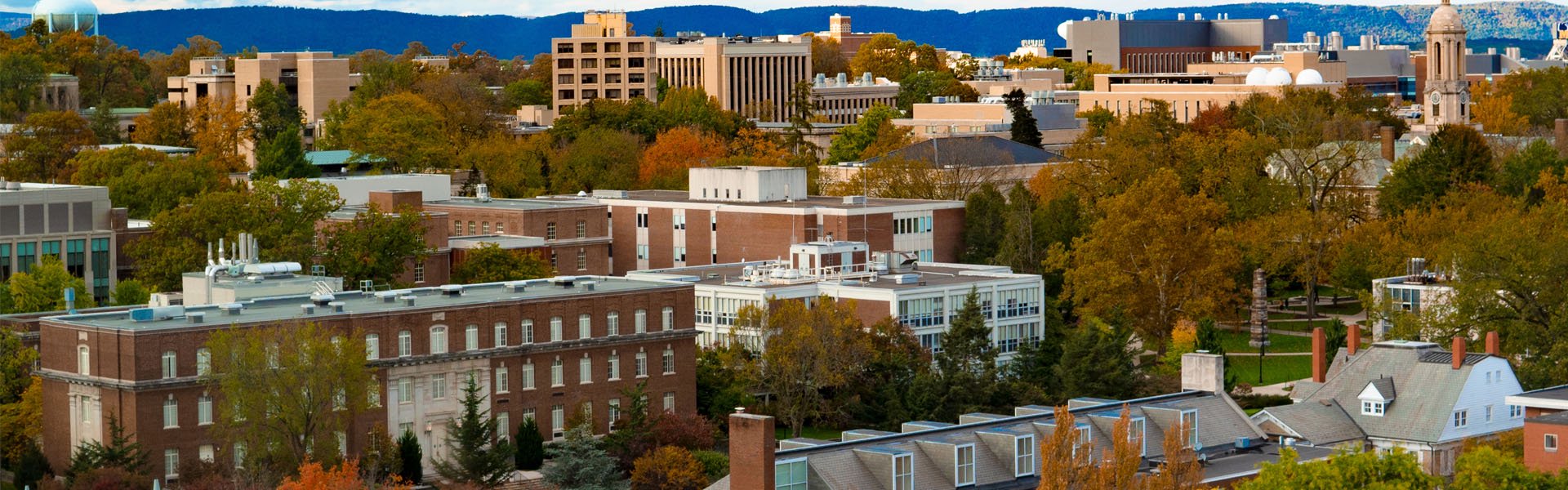 Aerial view of State College, Pennsylvania with fall foliage and a mix of campus and town buildings near Happy Valley Casino.