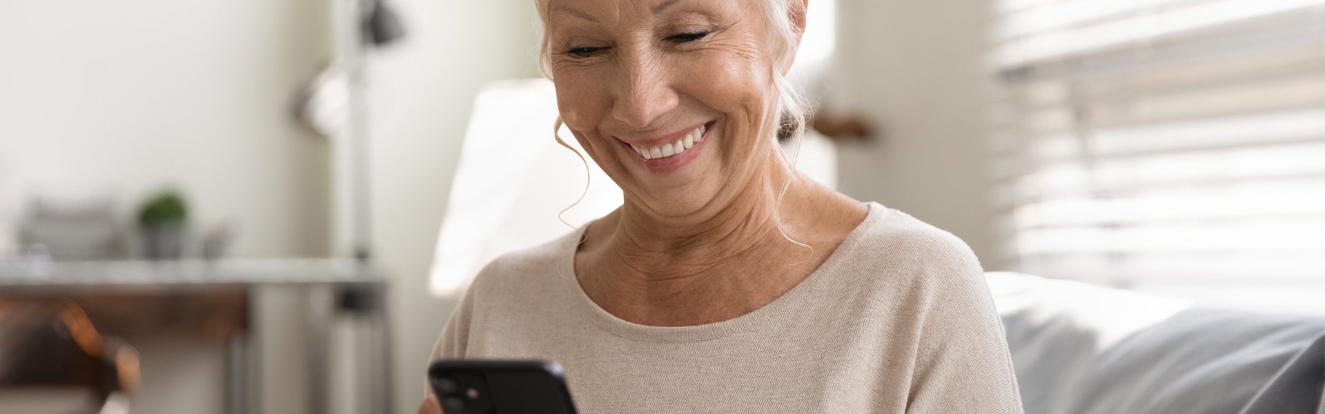 Older adult using a smartphone to access information independently for Happy Valley Casino in State College, Pennsylvania.