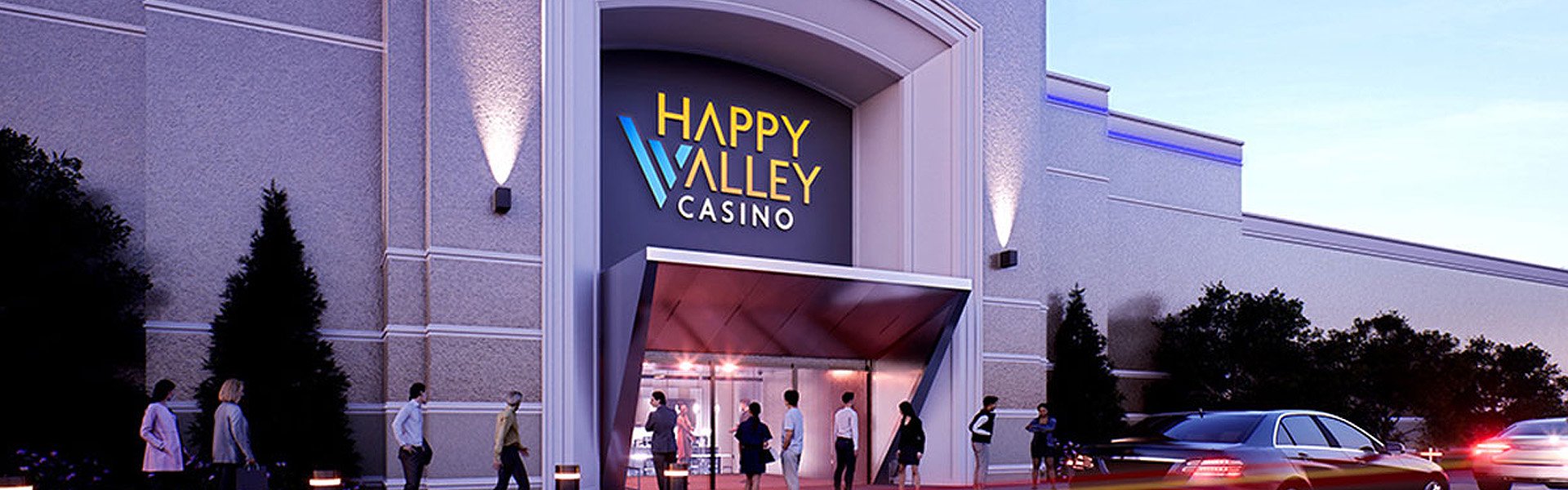 Guests walking toward the illuminated entrance of Happy Valley Casino at dusk in State College, Pennsylvania.